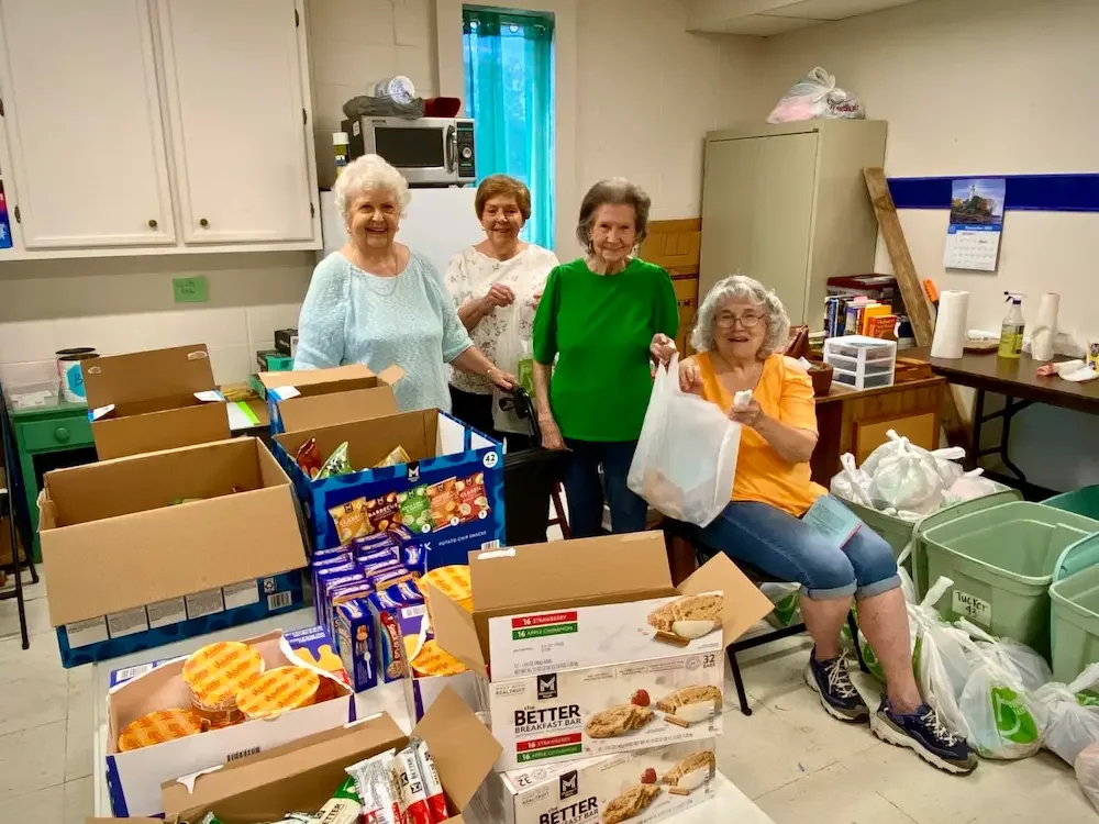 Blessing Bag Ministry volunteers serving by packing bags of food items to go to Ponchatoula public school students in need