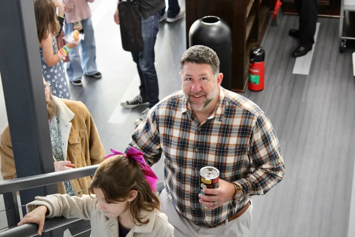 Man smiling on Sunday morning at connect hub where you can ask questions and submit prayer requests
