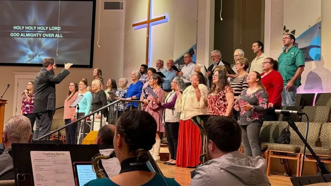 Sanctuary choir and orchestra leading worship in traditional service