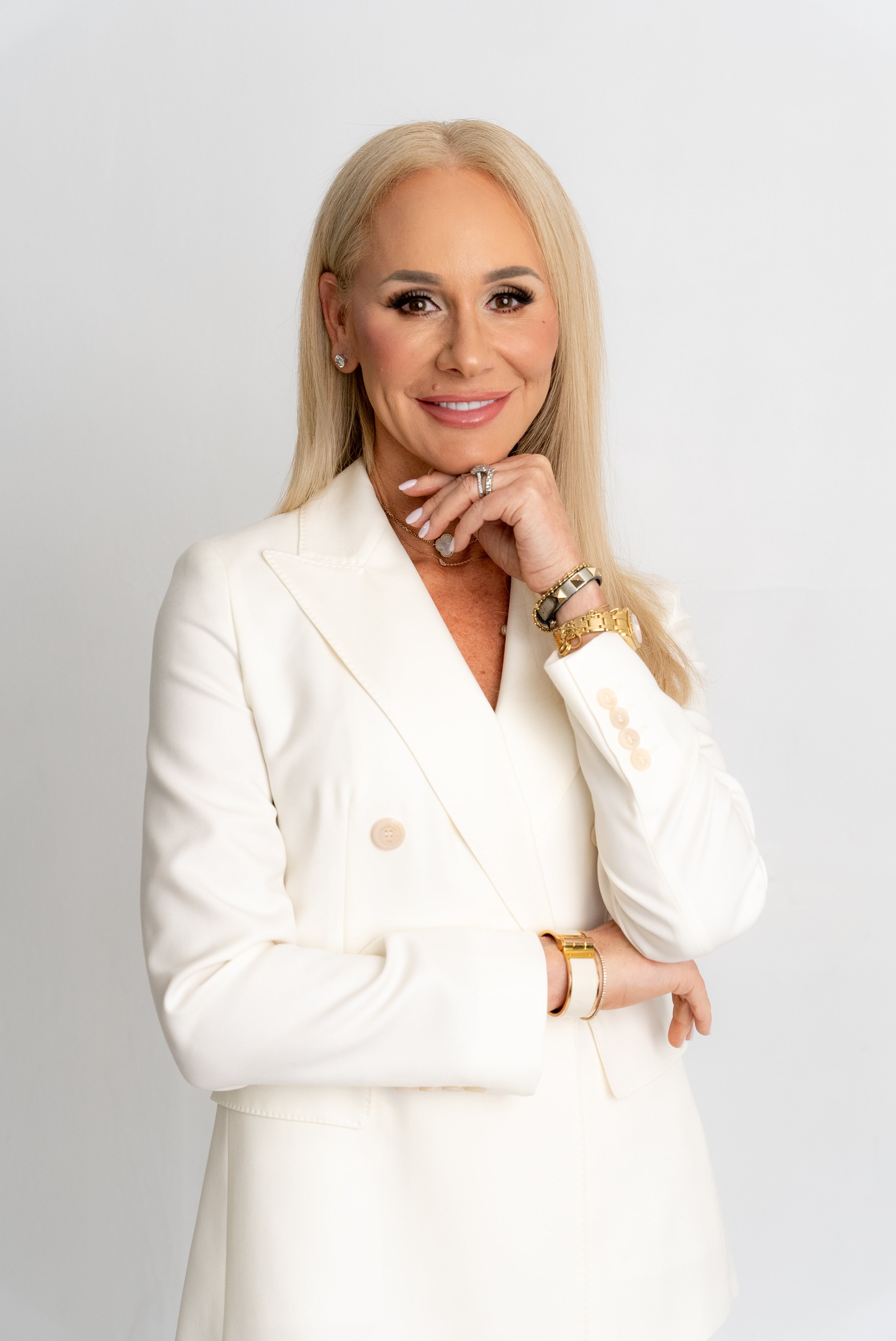 close up image of a woman in a white suit