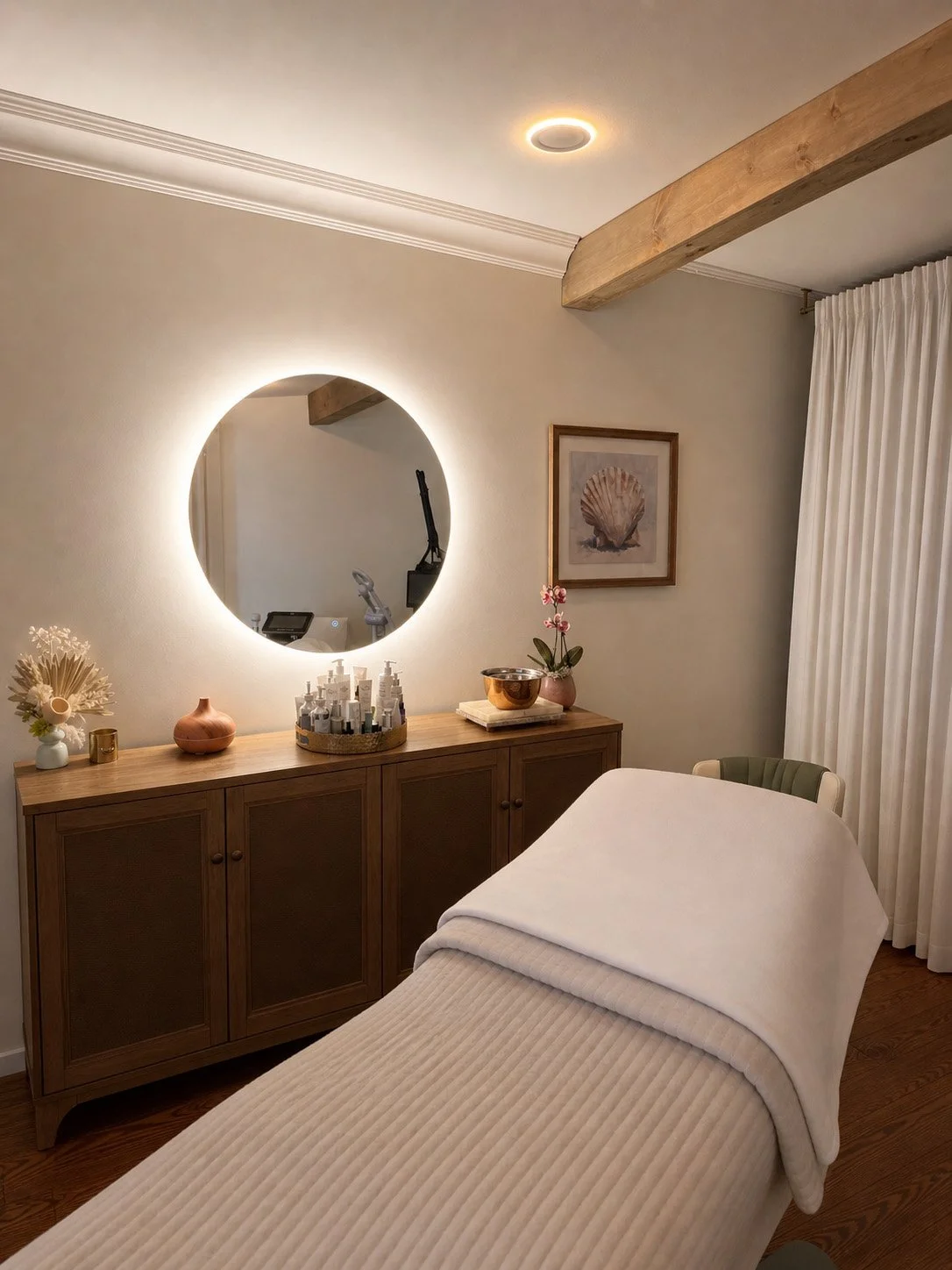 A medi spa room with a table and a wooden cabinet with skincare products.