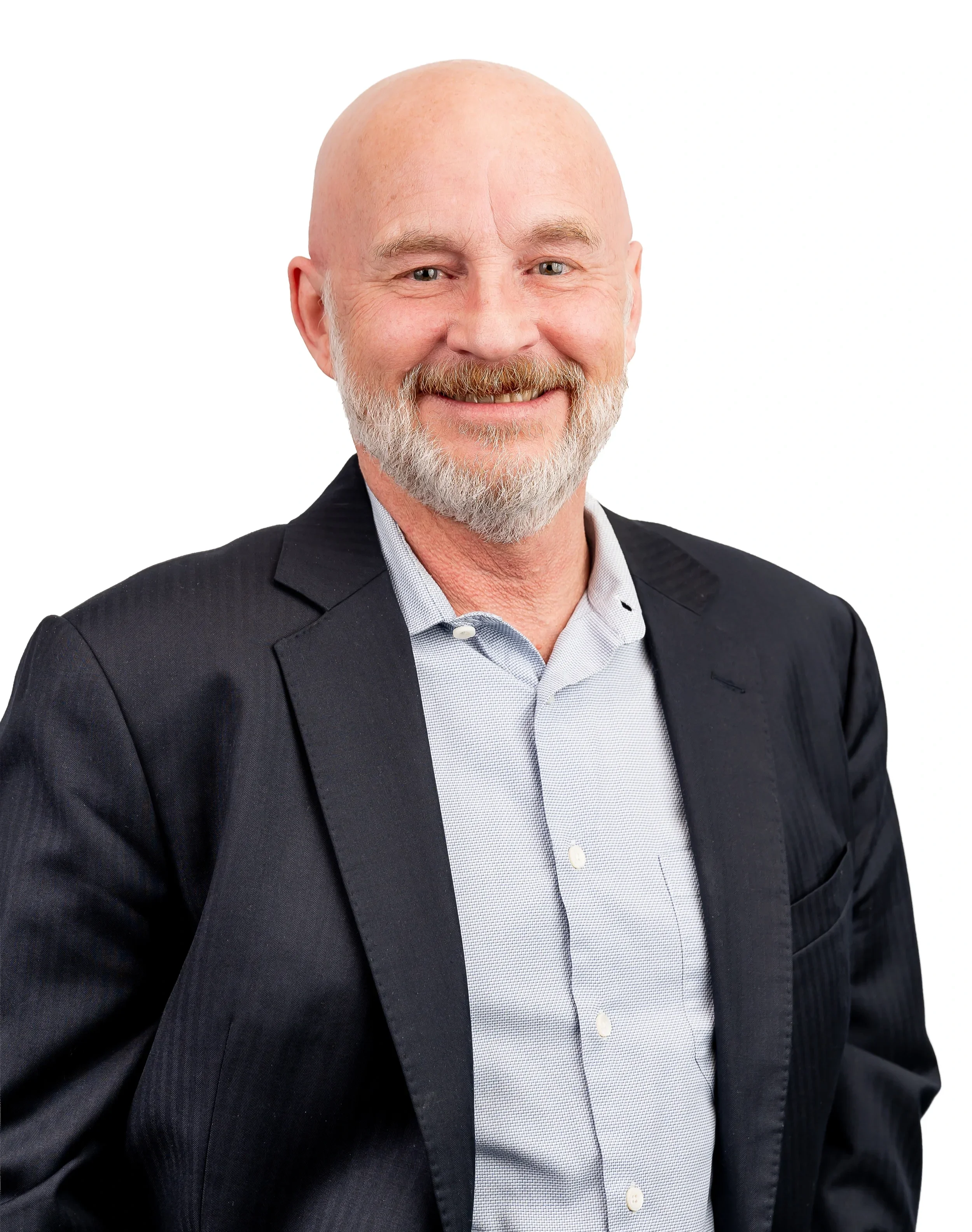 A middle-aged man with a bald head and a beard, wearing a black suit jacket over a light-colored collared shirt, smiling with a white background.