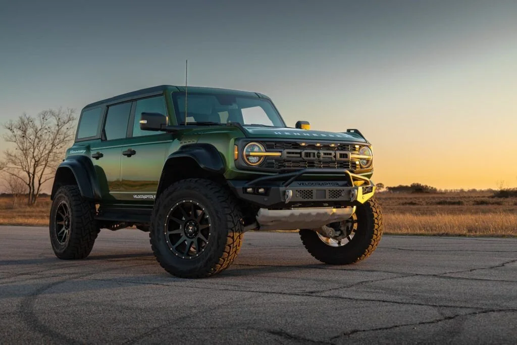 Close-up of the rear of a red Ford Bronco with "Hennessey" branding and a spare tire on the back.