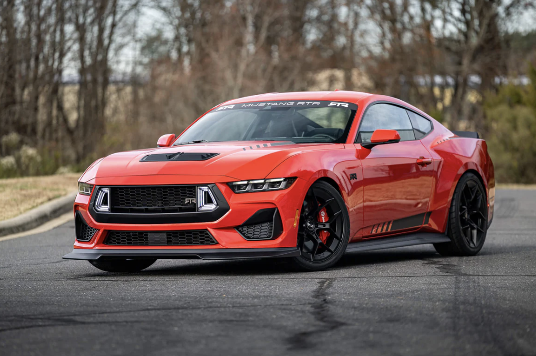 Close-up of a Mustang RTR front grille with a distinct design and emblem, featuring modern LED headlights.