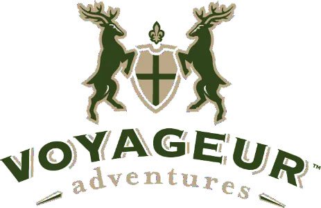 Voyageur Adventures logo featuring two reindeer holding a shield with a cross, and the words 'Voyageur Adventures' underneath.