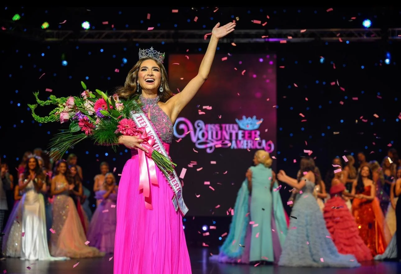 Miss Teen Volunteer America winner wearing a crown and sash, holding a bouquet, celebrating on stage with confetti and other contestants in evening gowns in the background.