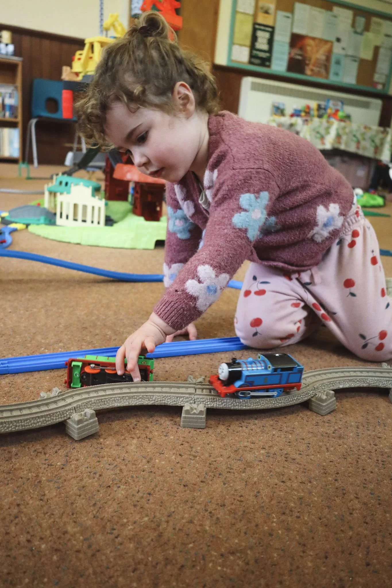 Toddler playing with train in Play session