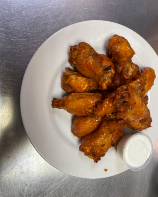 Plate of buffalo chicken wings with dipping sauce