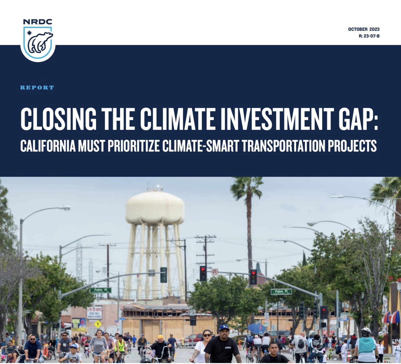 Cover page of a report titled "Closing the Climate Investment Gap: California Must Prioritize Climate-Smart Transportation Projects" with the NRDC logo. The, background shows a busy street in a city with people biking and walking, and a water tower in the distance.