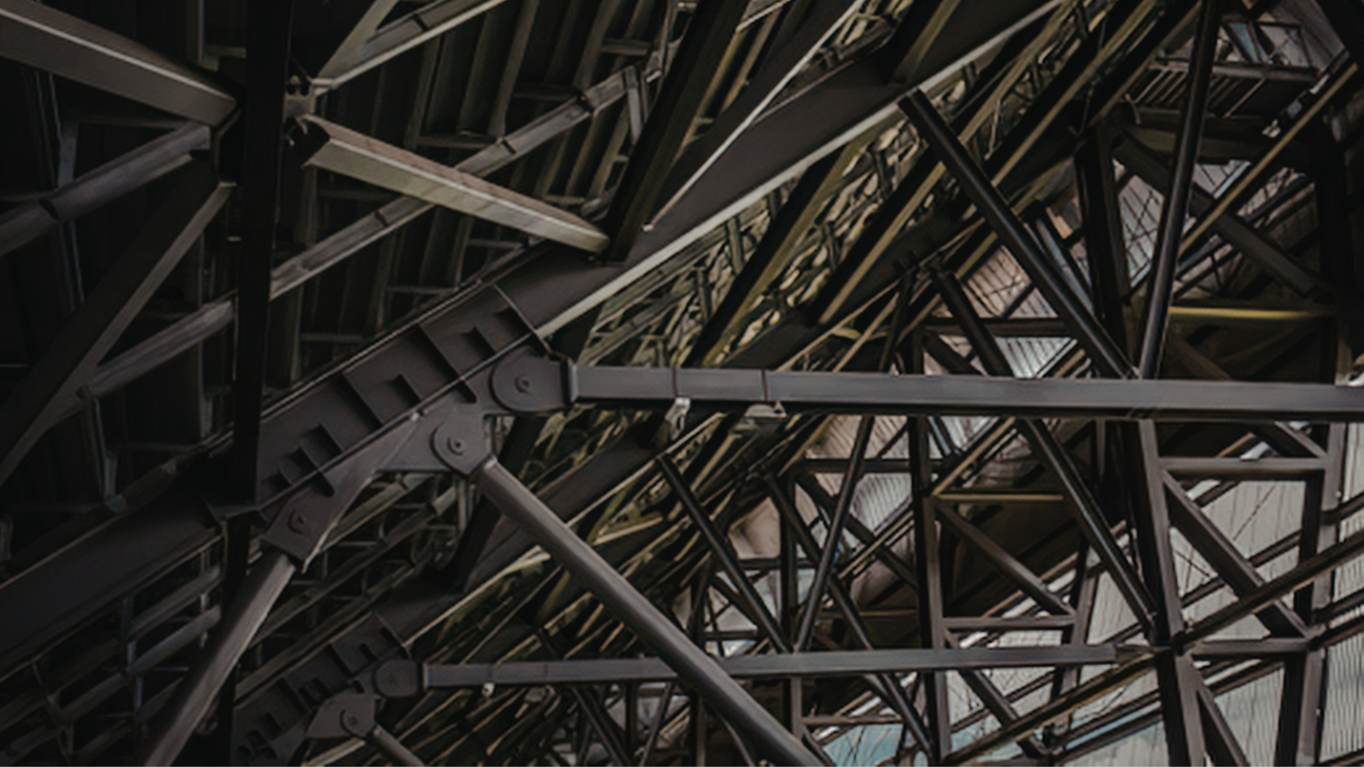 Close-up of a complex steel framework structure with beams and supports, part of a large construction or architectural installation.