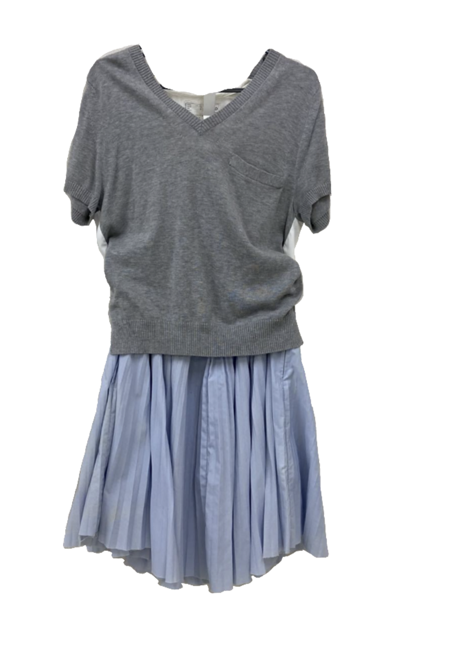 A mannequin dressed in a gray short-sleeve V-neck sweater and a light blue pleated skirt.