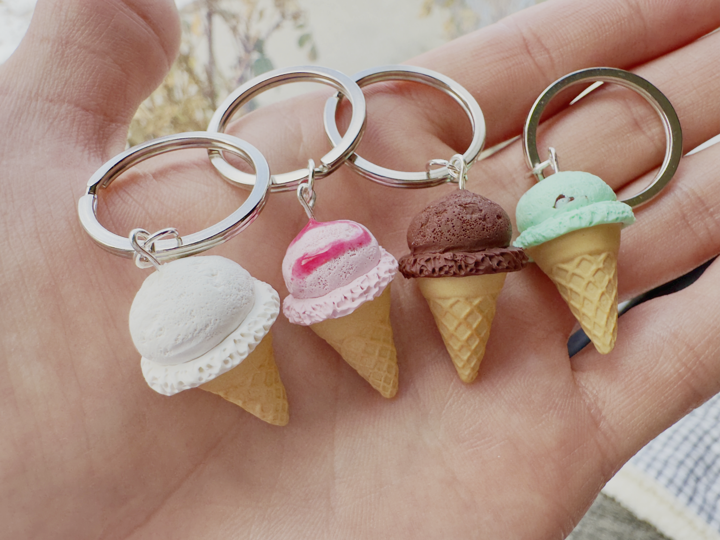 Keychains with ice cream cone charms featuring different ice cream flavors and colors.