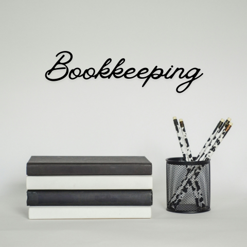 Bookkeeping services image with books and pencils symbolizing organization and financial management