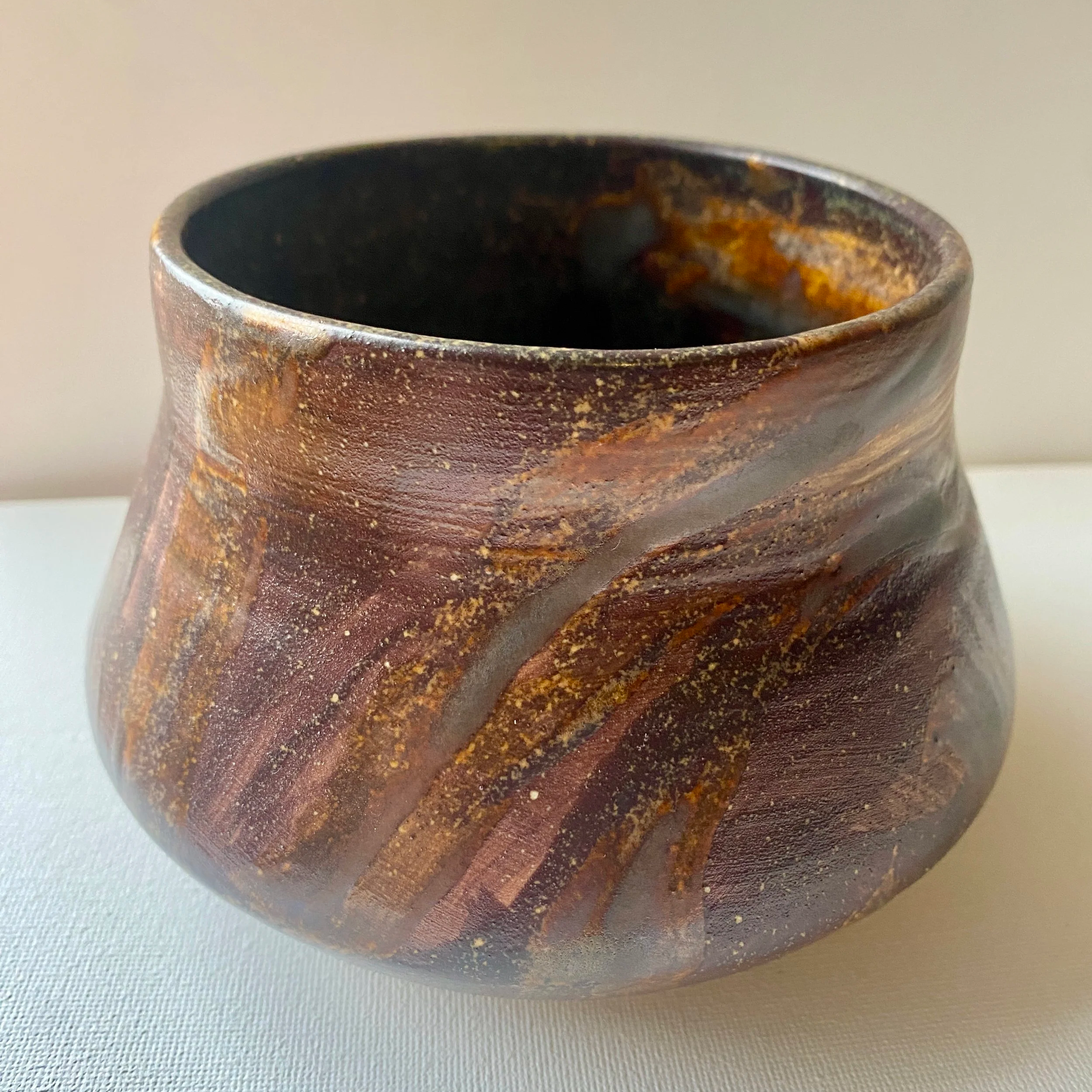 large brown vase with brown tone lines in the glaze