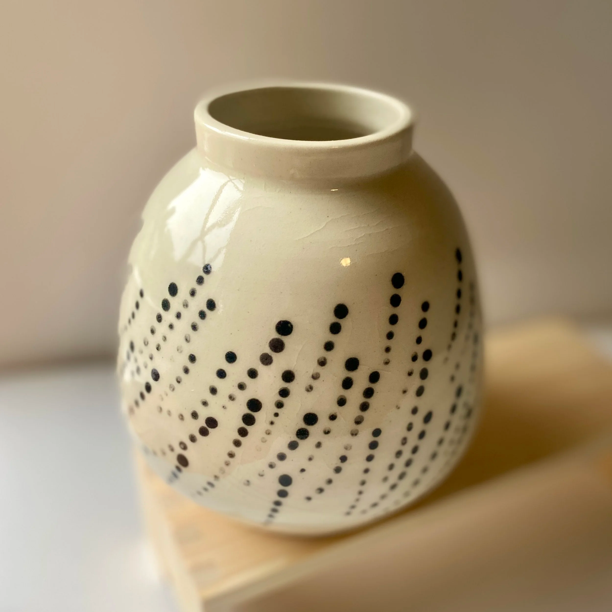 cream vase with black dots