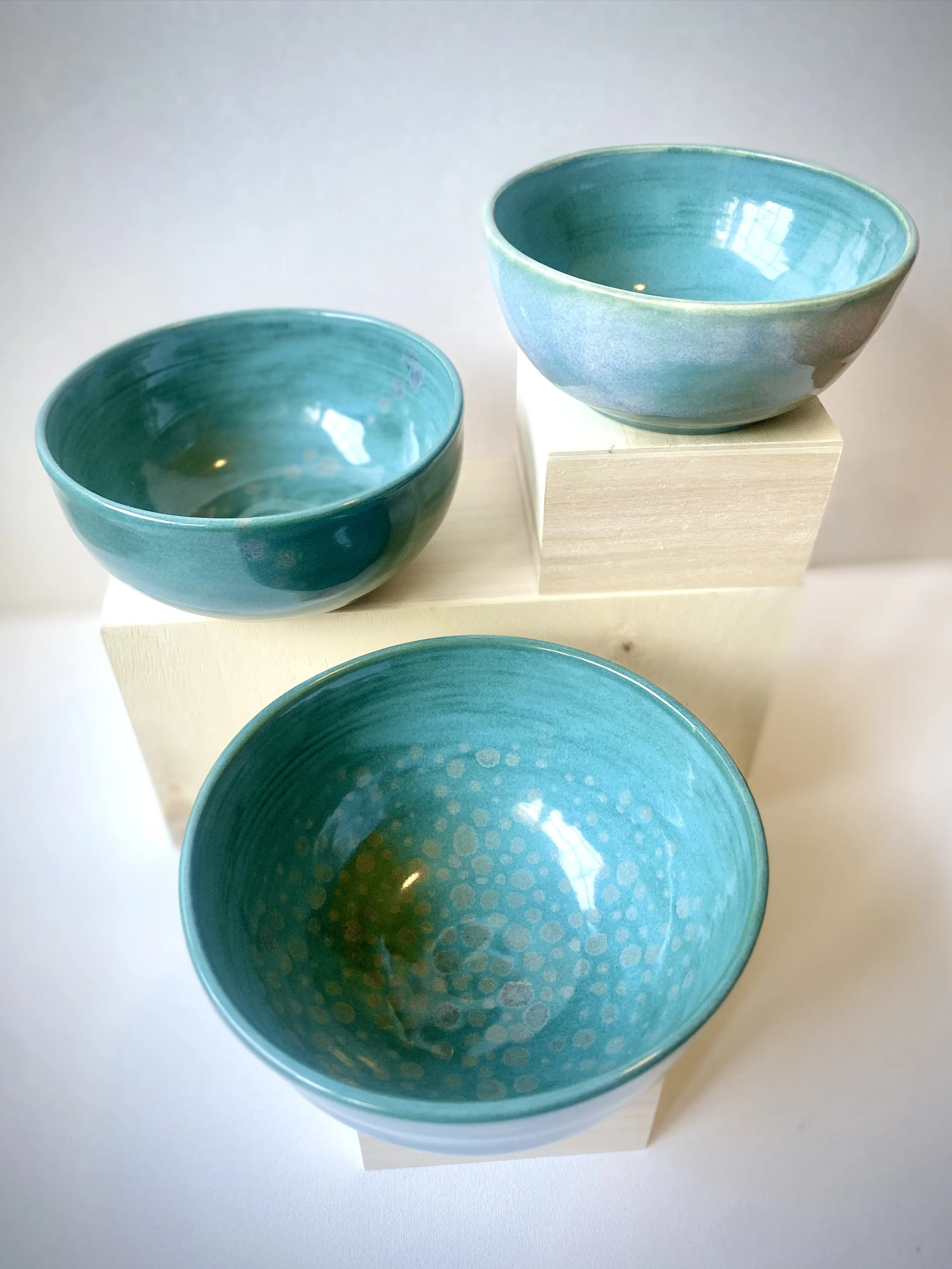 three turquoise serving bowls