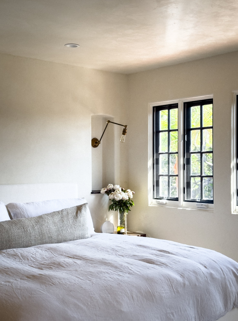 A cozy bedroom with walls showing subtle texture and movement.