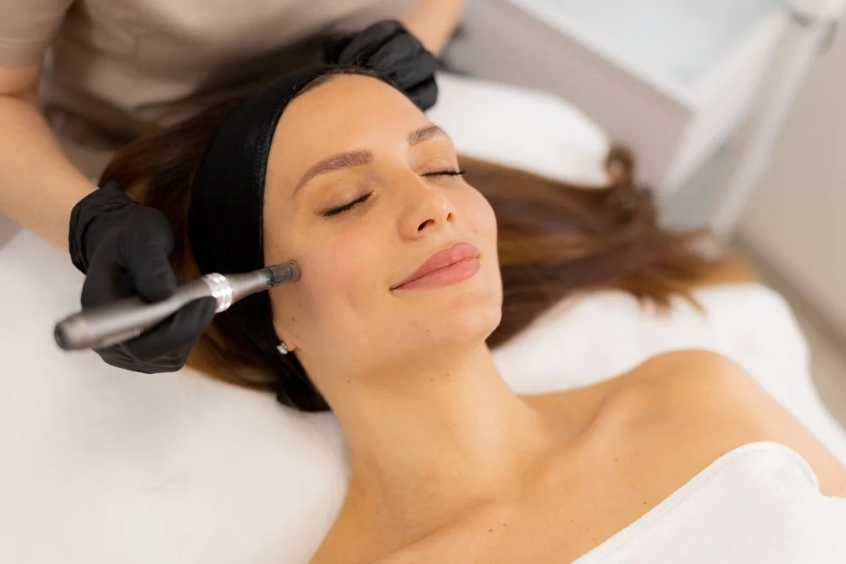 Woman laying down to get a microneedling treatment on her face.