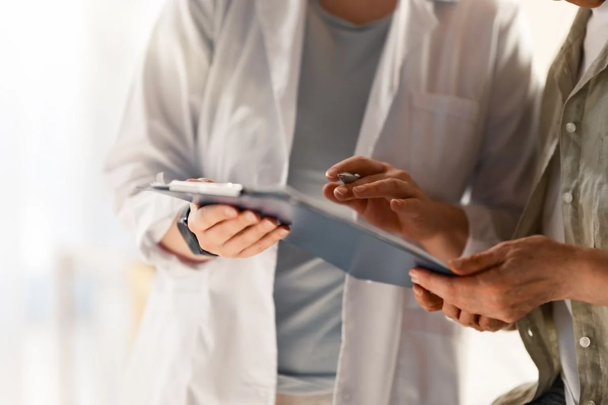 Provider and patient reviewing medical records during a functional medicine treatment.