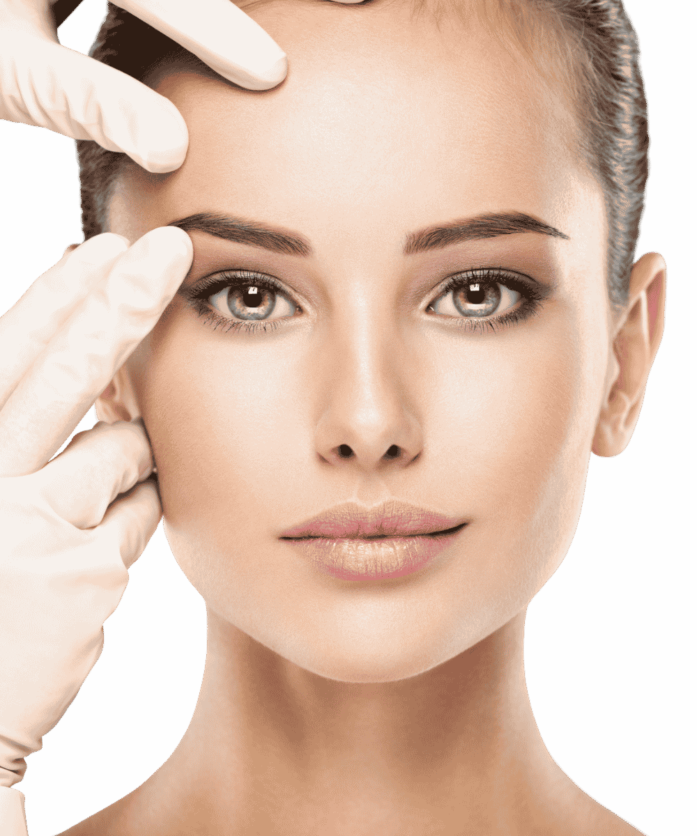 A woman with flawless skin and light makeup receives a cosmetic or dermatological examination, with a gloved hand gently touching her forehead and cheek.