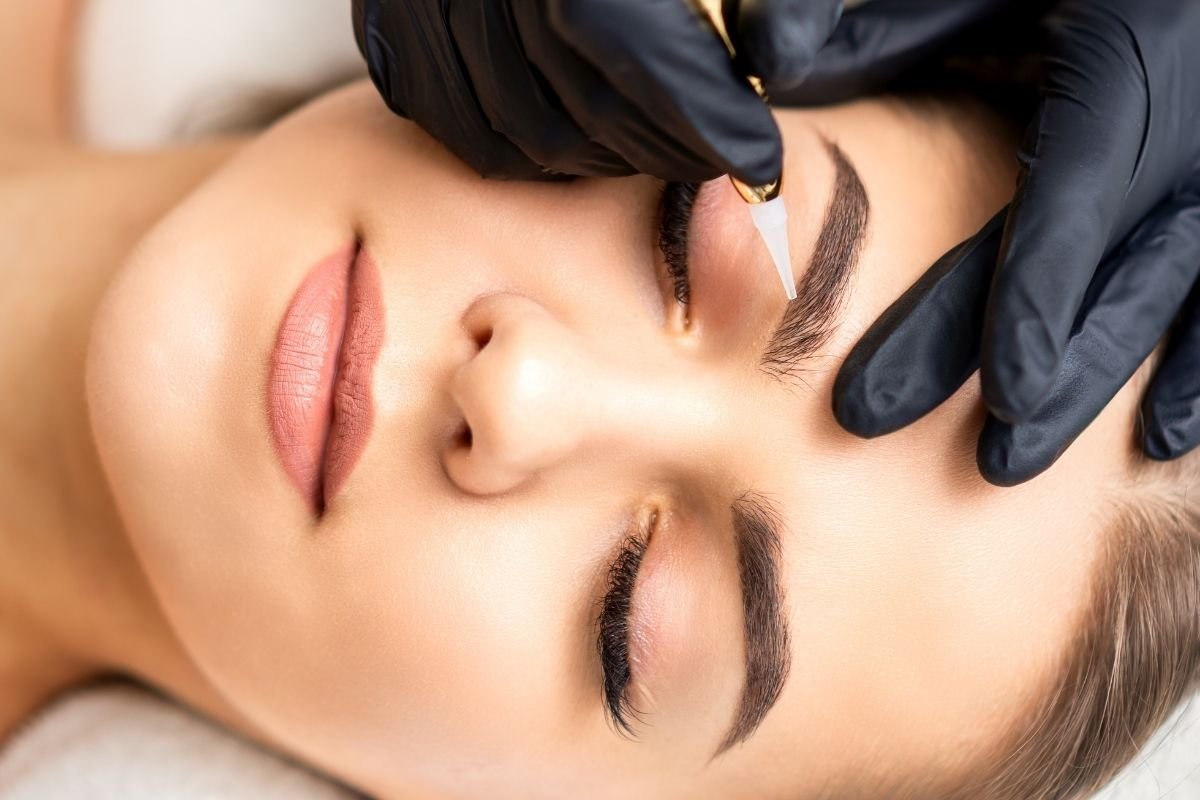 Woman receiving permanent makeup on her eyebrows.