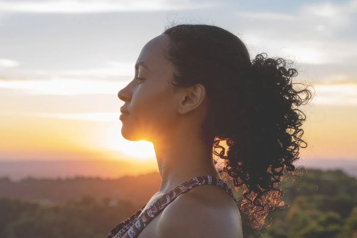 Woman outside at sunset.