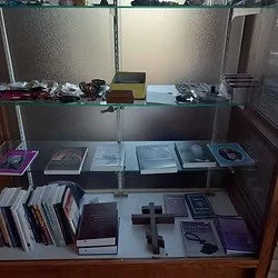 Saint George Orthodox Cathedral bookstore display case with religious books, crosses, and other religious items on shelves