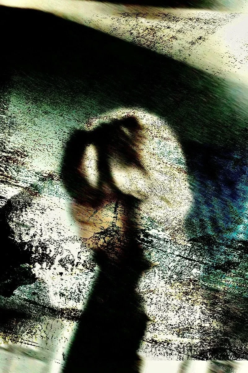 A distorted, blurry reflection of Charles Xu with long hair, standing in front of a textured background.