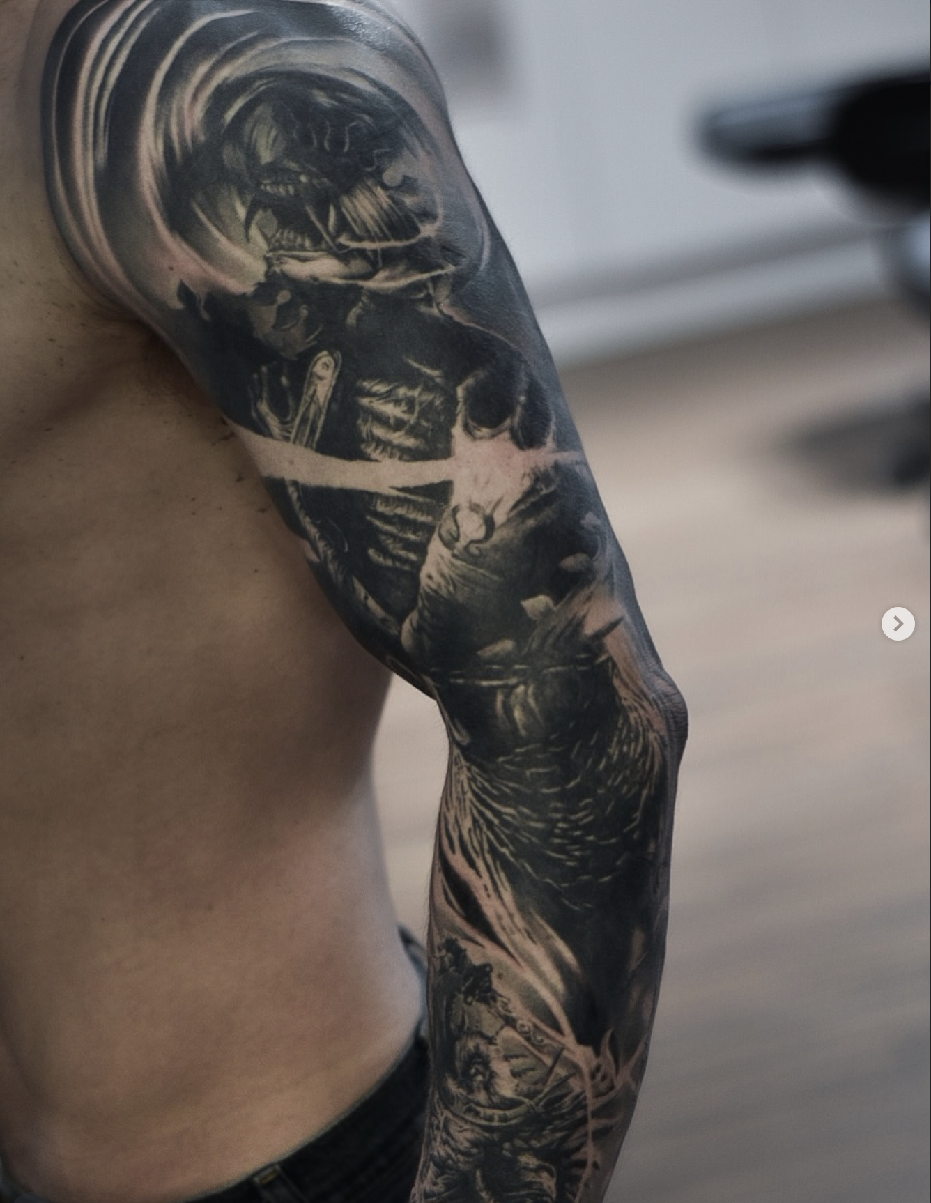 Black and gray tattoo of a Panther on a person's arm, with detailed shading and realistic style.