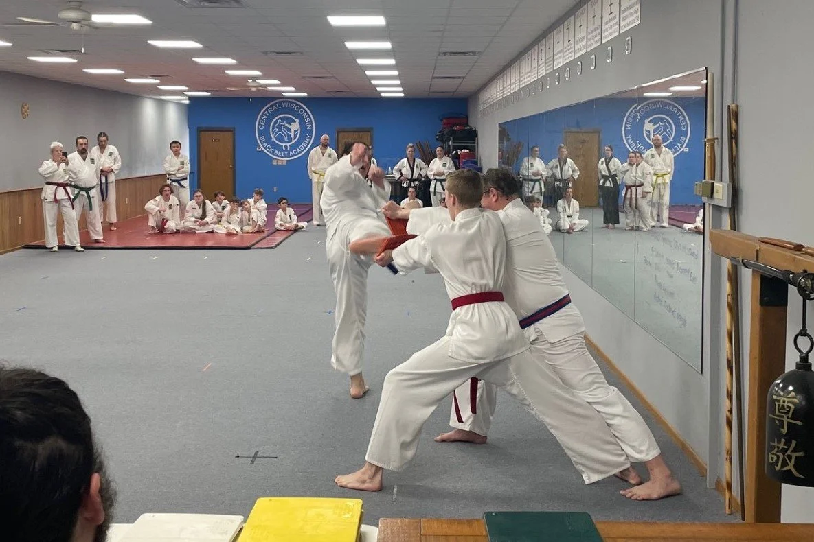 test breaking students looking on from the mat.