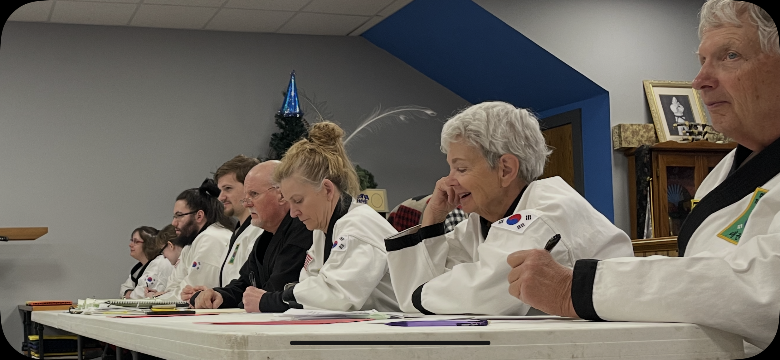 A black belt judging panel at a 2026 exam