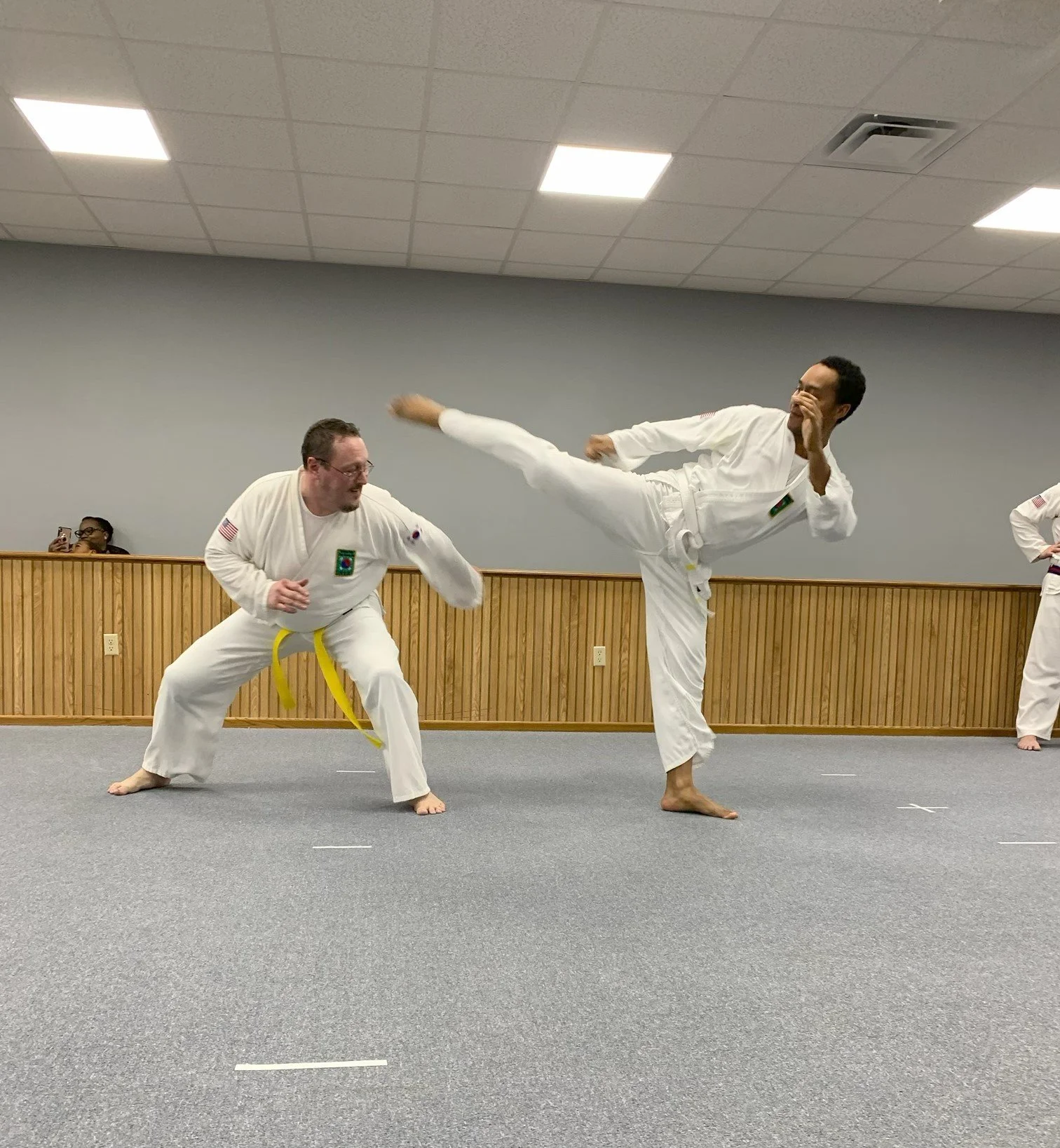 Soft Sparring during the test. Kicks and black can be seen.
