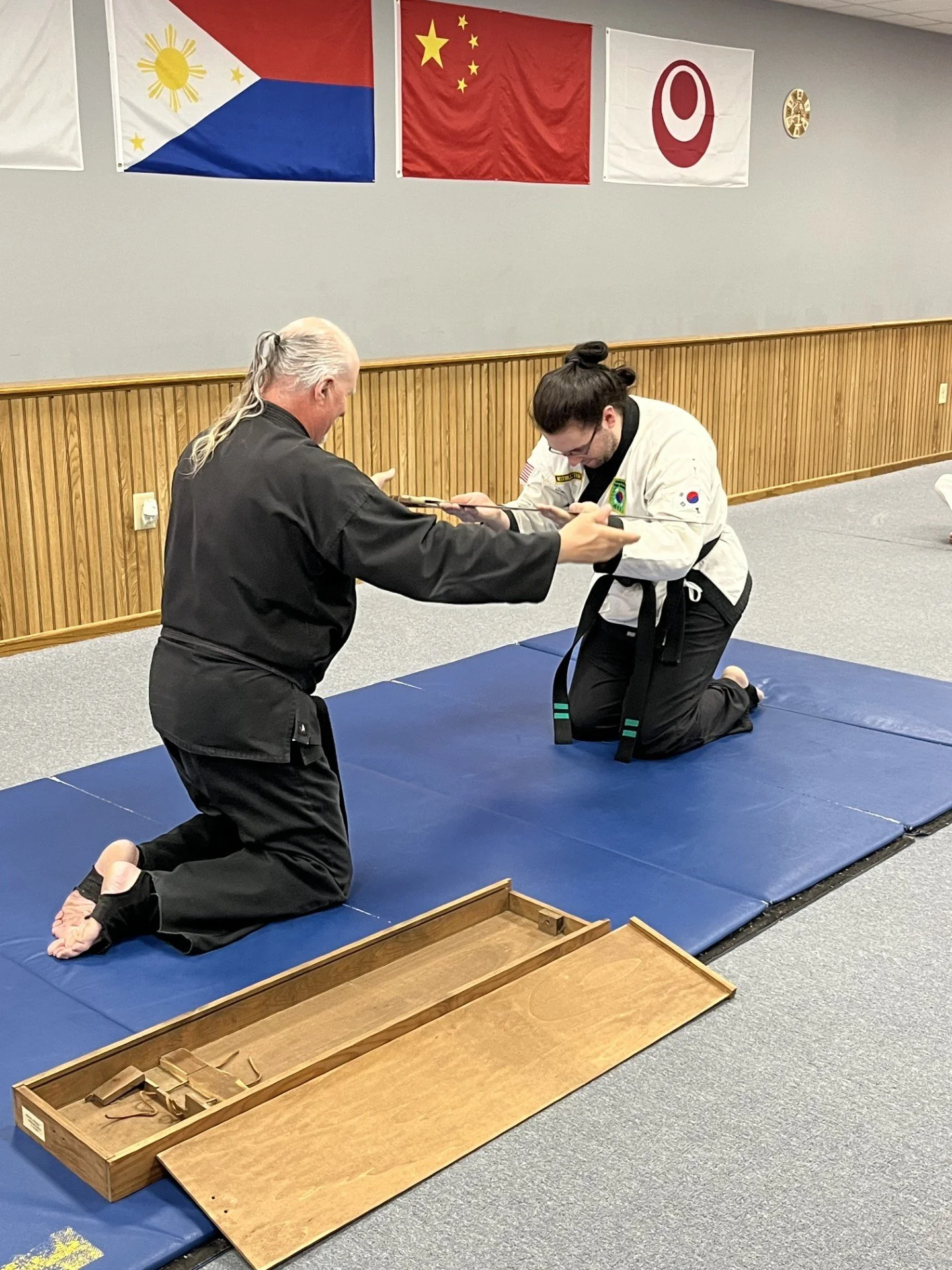 2nd Dan blackbelt receiving his kitana - a sign of achievement and merit