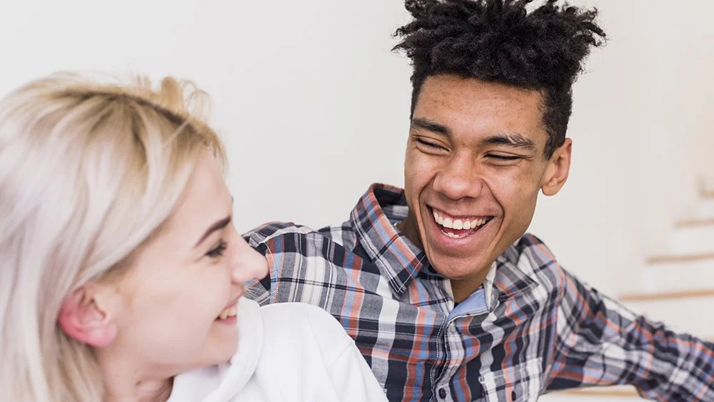 Teen smiling during conversation, representing emotional support