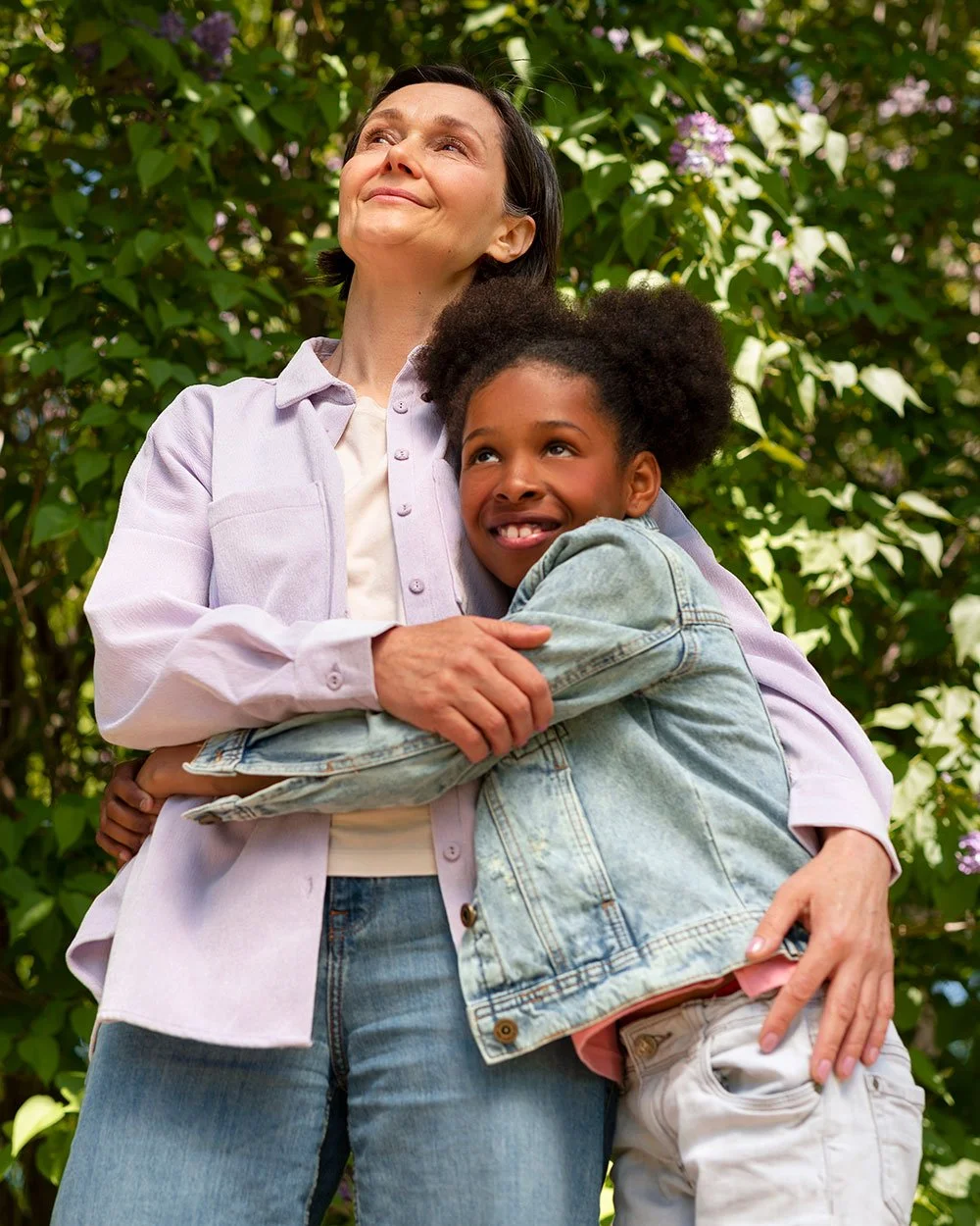 Mother holding young child outdoors, representing supportive family therapy and emotional connection