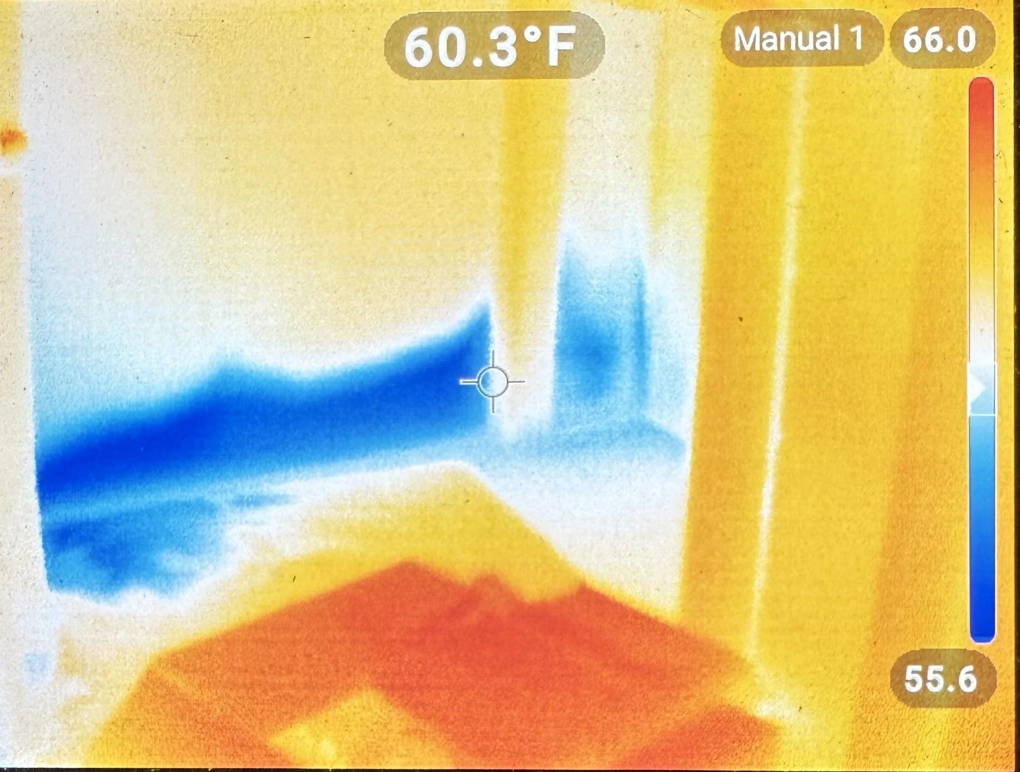 Thermal imaging display showing temperature readings with a crosshair at the center, featuring a color scale from blue to red indicating temperature variations, with specific temperatures of 60.3°F and 55.6°F marked.