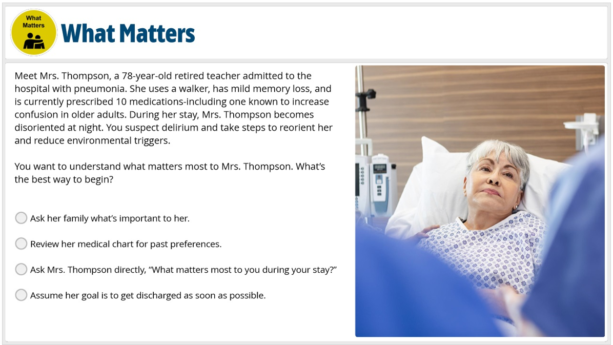 An elderly woman with gray hair lying in a hospital bed, looking at a healthcare provider. Medical equipment is visible beside her.