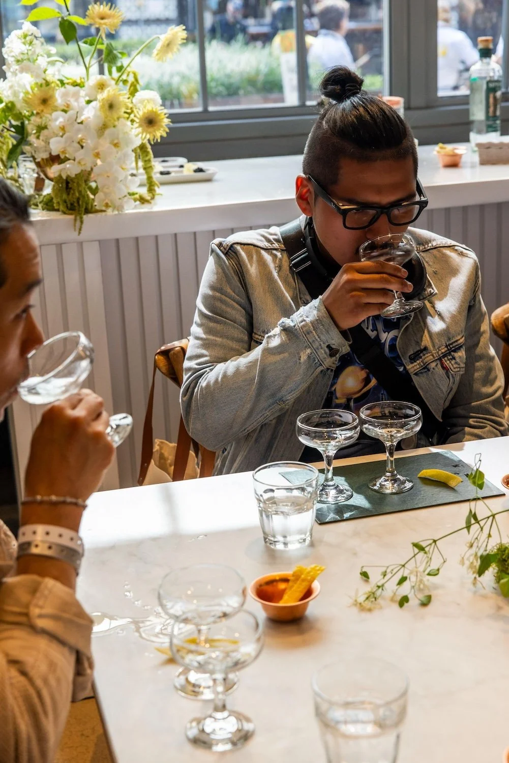 Martini Expo attendee tasting spirits.