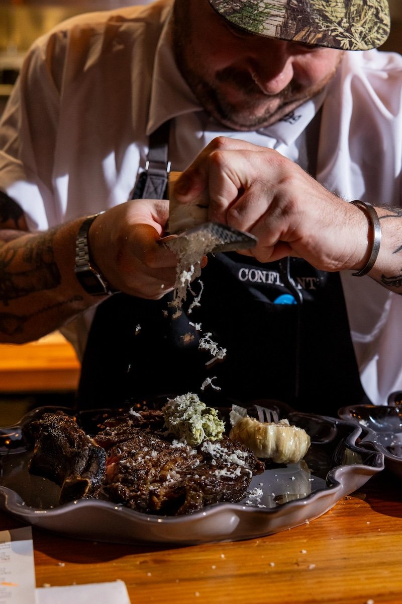 Chef finishing a steak at Martini Expo dinner series.