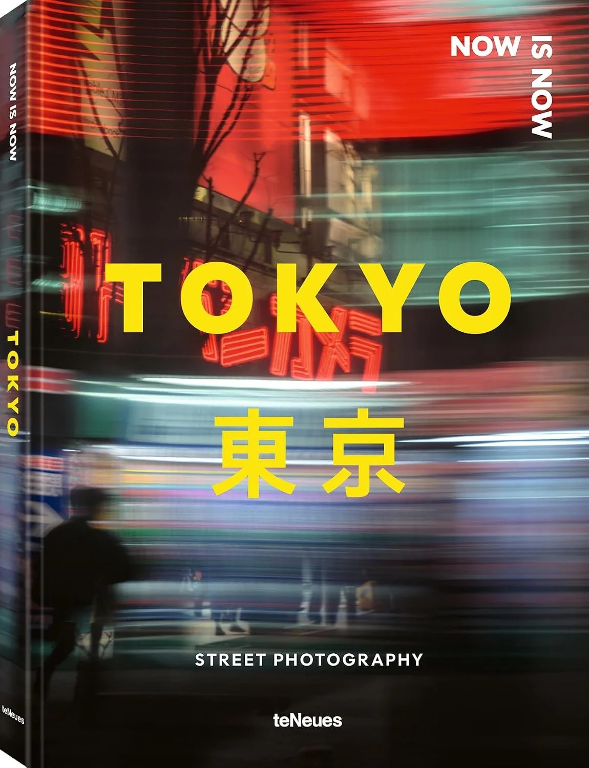 Cover of a book titled 'TOKYO' with Japanese characters below, featuring a blurred city street scene with neon lights at night.