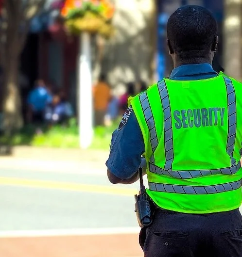 A public safety officer patrolling on foot on campus.