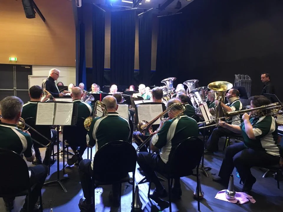 Brass Band  on stage with conductor