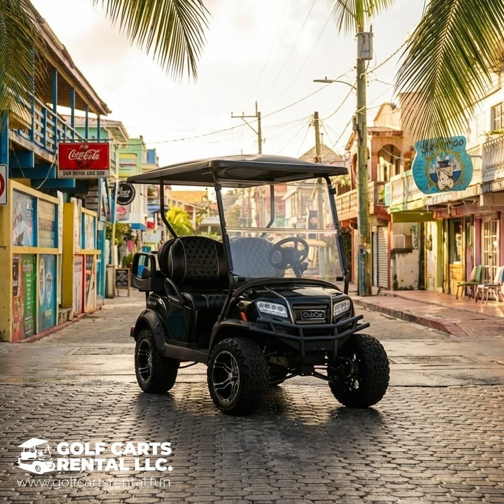 A black golf cart parked on a cobblestone street in a colorful, tropical town with palm trees and storefronts.
