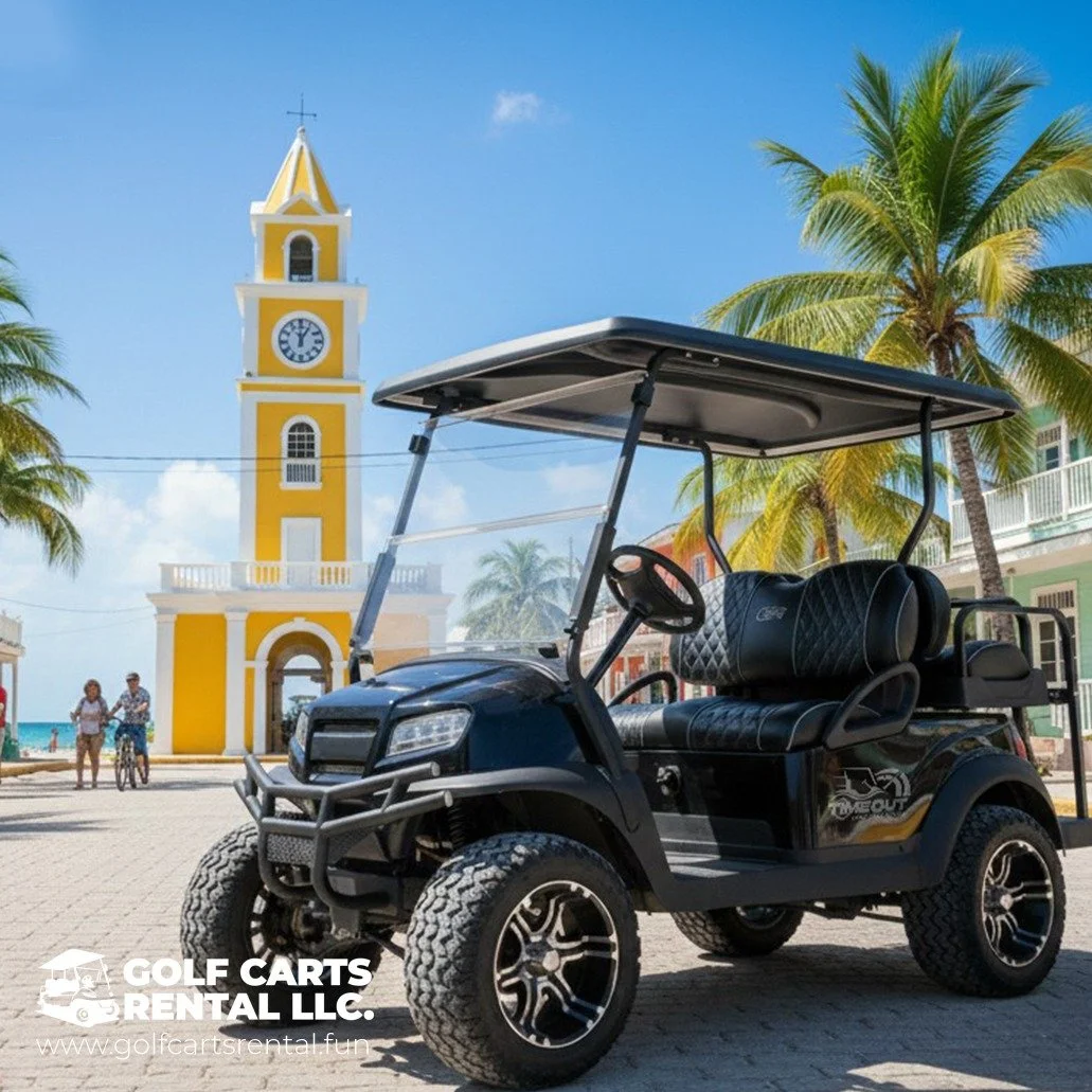A black golf cart parked on a brick street in front of a yellow and white clock tower, with palm trees and colorful buildings in the background, under a clear blue sky.