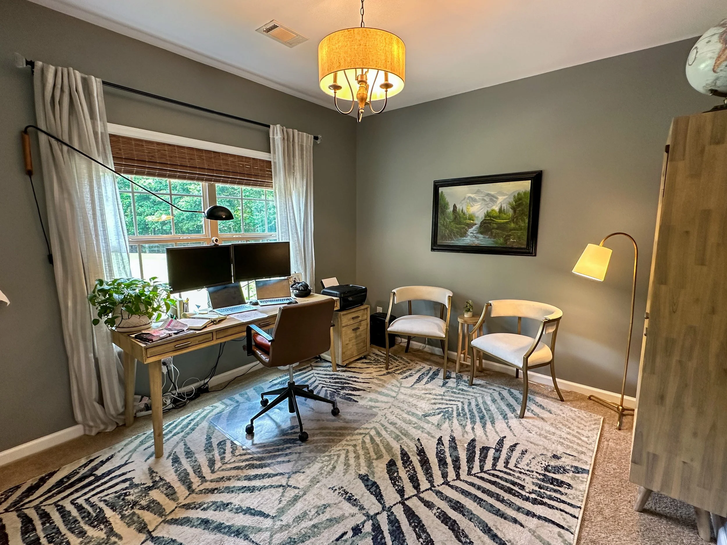 Home office with sage green walls, bamboo window coverings, light oak desk--Casa Limones interior design