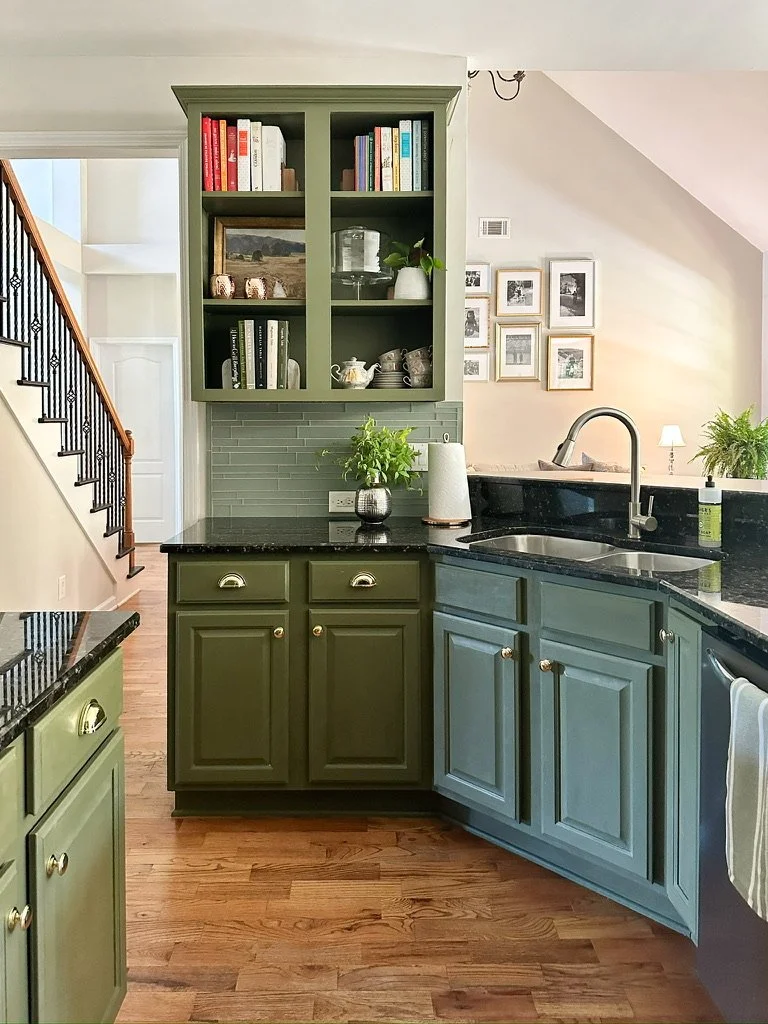 Olive green kitchen with black granite countertops and open shelving--Casa Limones interior design
