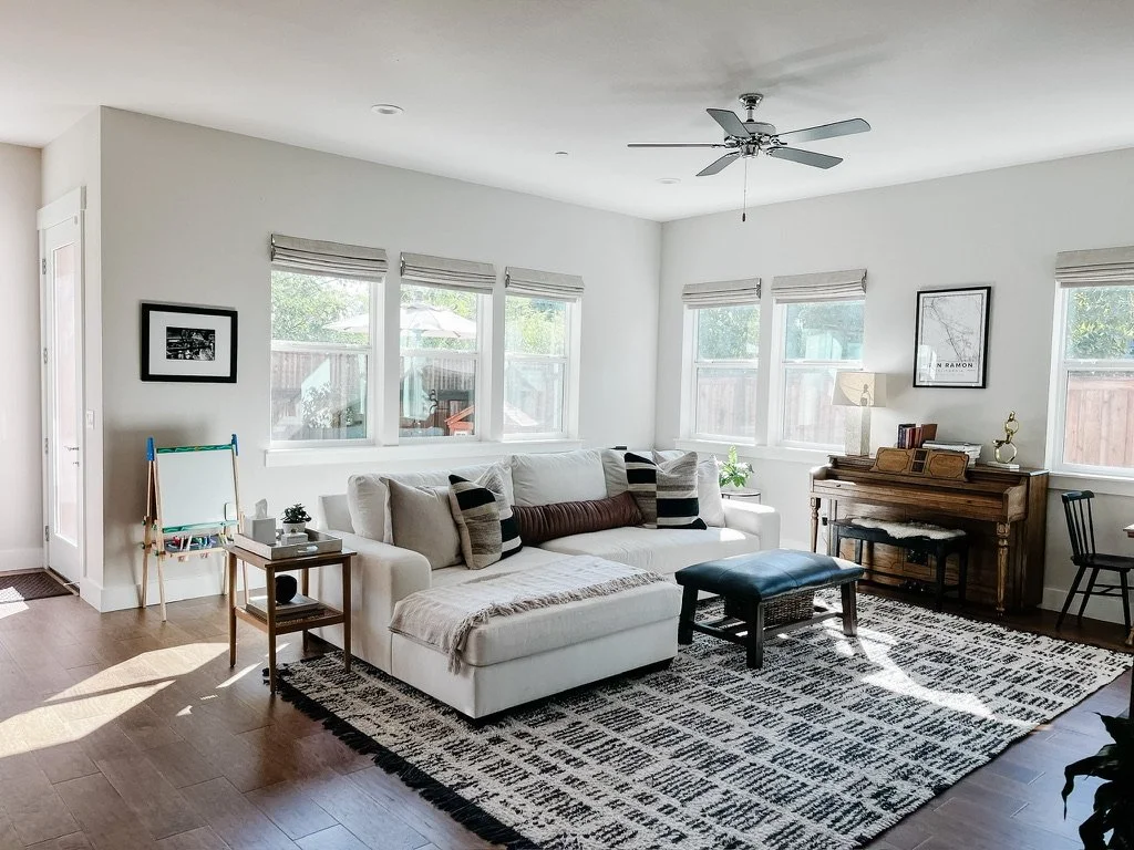 Light and neutral living room family room with piano Casa Limones interior design Atlanta