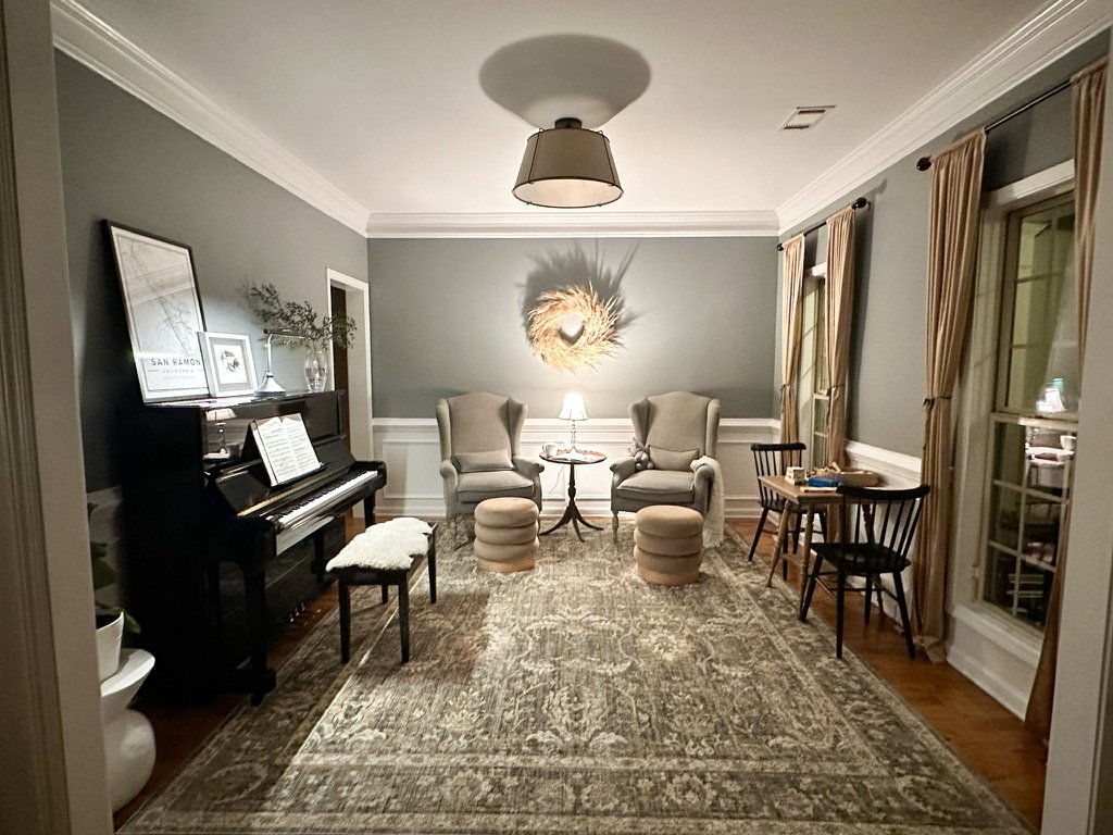 Piano music room parlor with wingback chairs and vintage rug--Casa Limones interior design