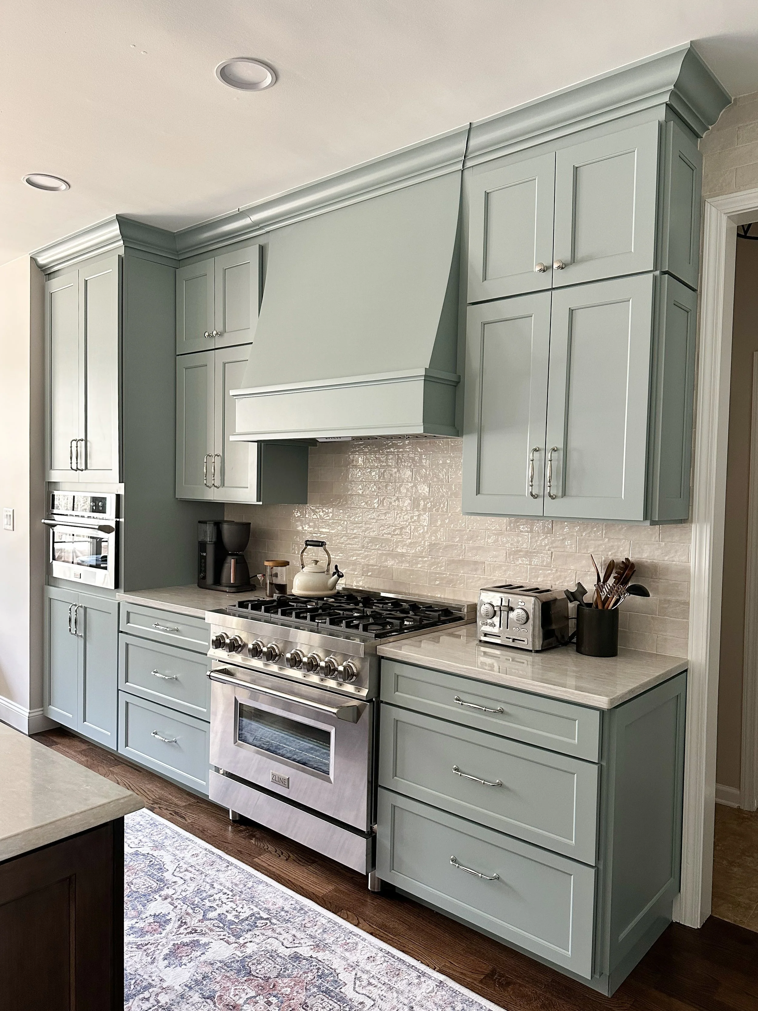Light blue kitchen with white quartz countertops, polished nickel hardware, and vintage runner--Casa Limones interior design