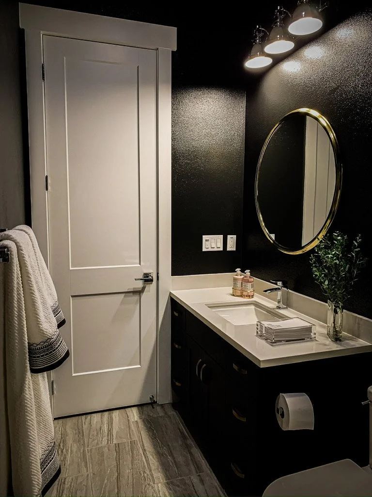 Dark and moody guest bathroom with brass accents--Casa Limones interior design